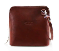 A dark brown leather crossbody bag with a wrist strap, silver-tone hardware, and a debossed logo on the front, shown against a plain white background.