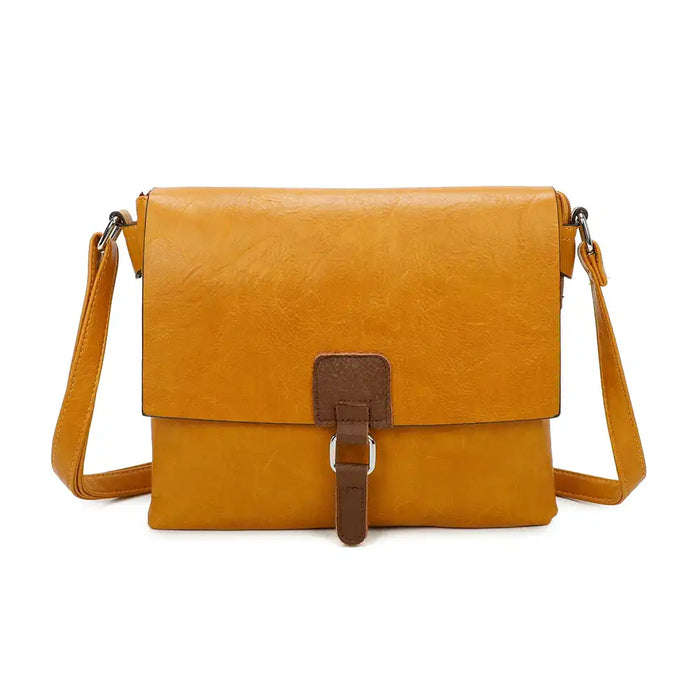 Mustard coloured satchel bag with a flap. Flap has a brown coloured tab that has a silver coloured hoop.