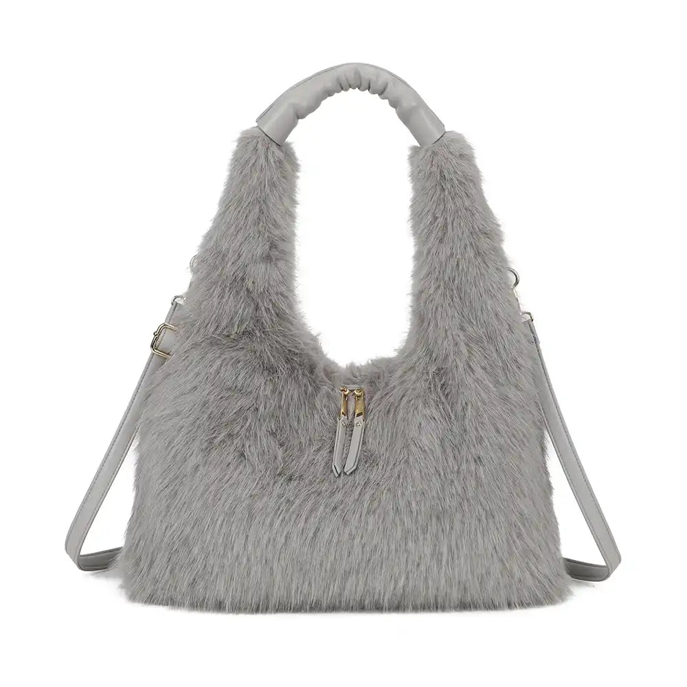 A light grey faux fur shoulder bag with a matching grey top handle and shoulder strap, featuring a small gold zipper pull accent on the front.
