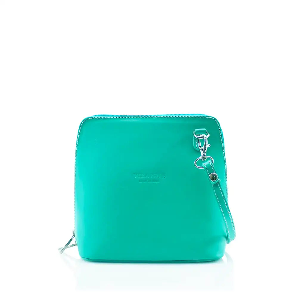 Square turquoise coloured bag with silver hardware. Silver loop leads to a silver clip that attaches the strap.