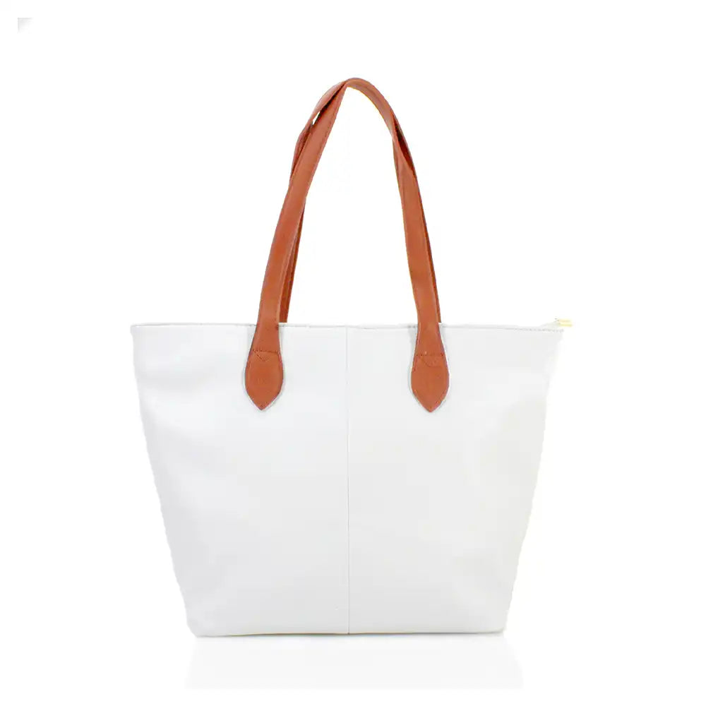 White tote bag with brown leather handles on a white background