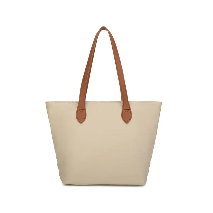 Cream tote bag with tan brown shoulder straps. On a white background.