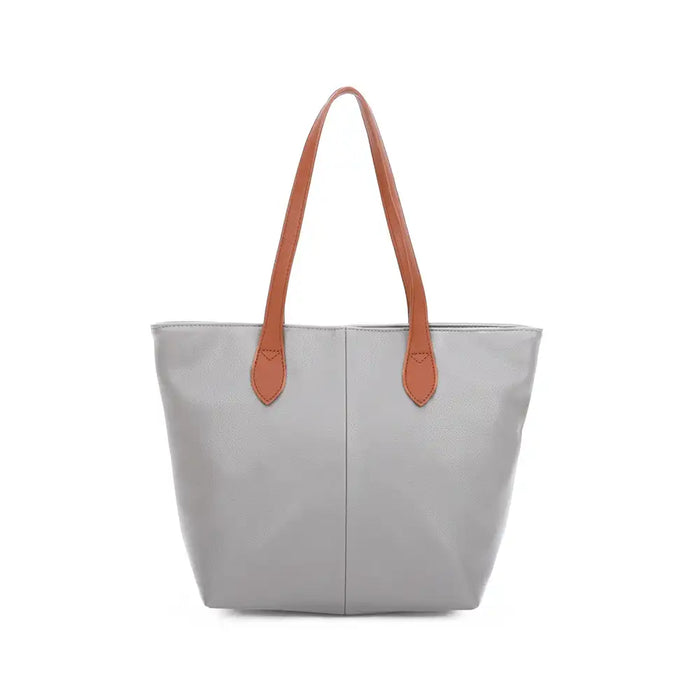 Pale Grey  tote bag with tan brown shoulder straps. On a white background.