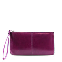Purple coloured purse with purple coloured wrist strap.