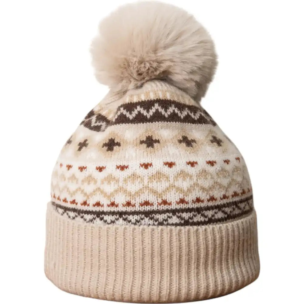 Knitted beanie with a pattern and pom-pom on a white background