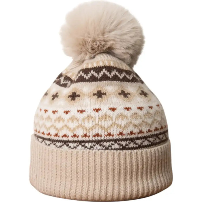 Knitted beanie with a pattern and pom-pom on a white background