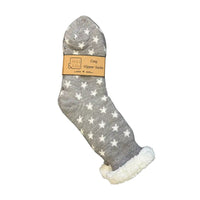 A single gray slipper sock with white star patterns and a white sherpa lining, shown on a plain white background with its paper packaging label attached.