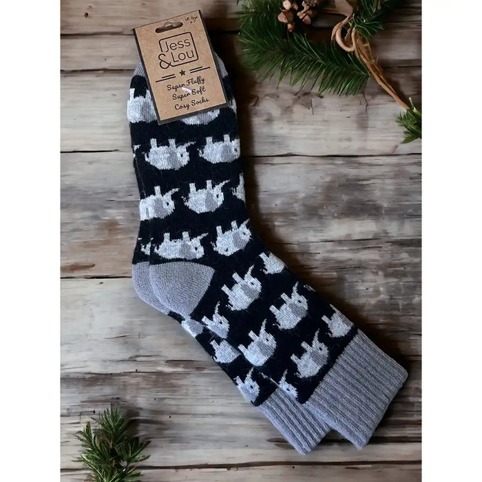 Black background sock with a grey ribbed ankle cuff, heel and toe area. Featuring grey elephants.