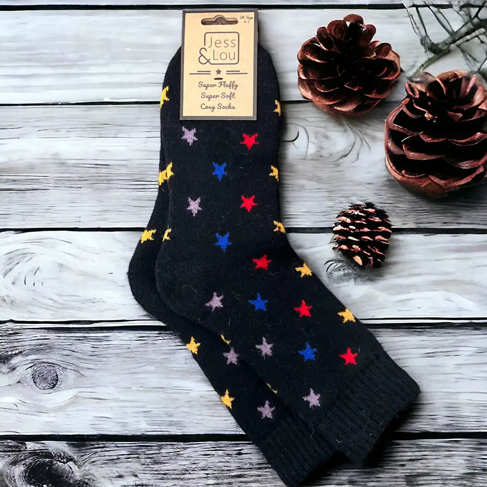 Black back ground socks with a  multi coloured star print with a ribbed black ankle cuff.