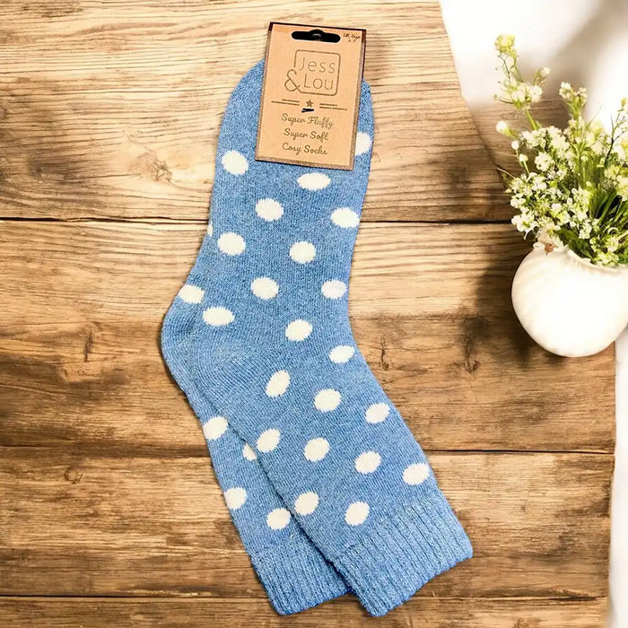 Cornflower blue based socks with large white spots and a ribbed ankle cuff in cornflower blue. 