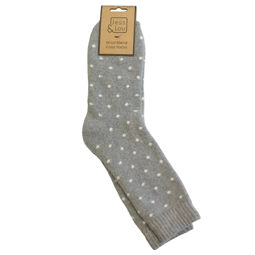 A pair of gray wool blend socks with small white polka dots, hanging from a  paper hanger that reads 'Jess & Lou'.