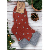 Rusted orange background sock with grey stars and a turned down grey ankle cuff