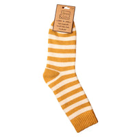 Striped sock with gold and white stripe pattern on a white background, featuring a Jess & Lou label.
