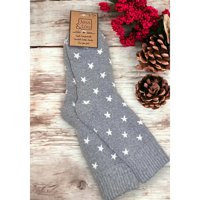 Pale back ground socks with an off white star print with a ribbed grey ankle cuff.