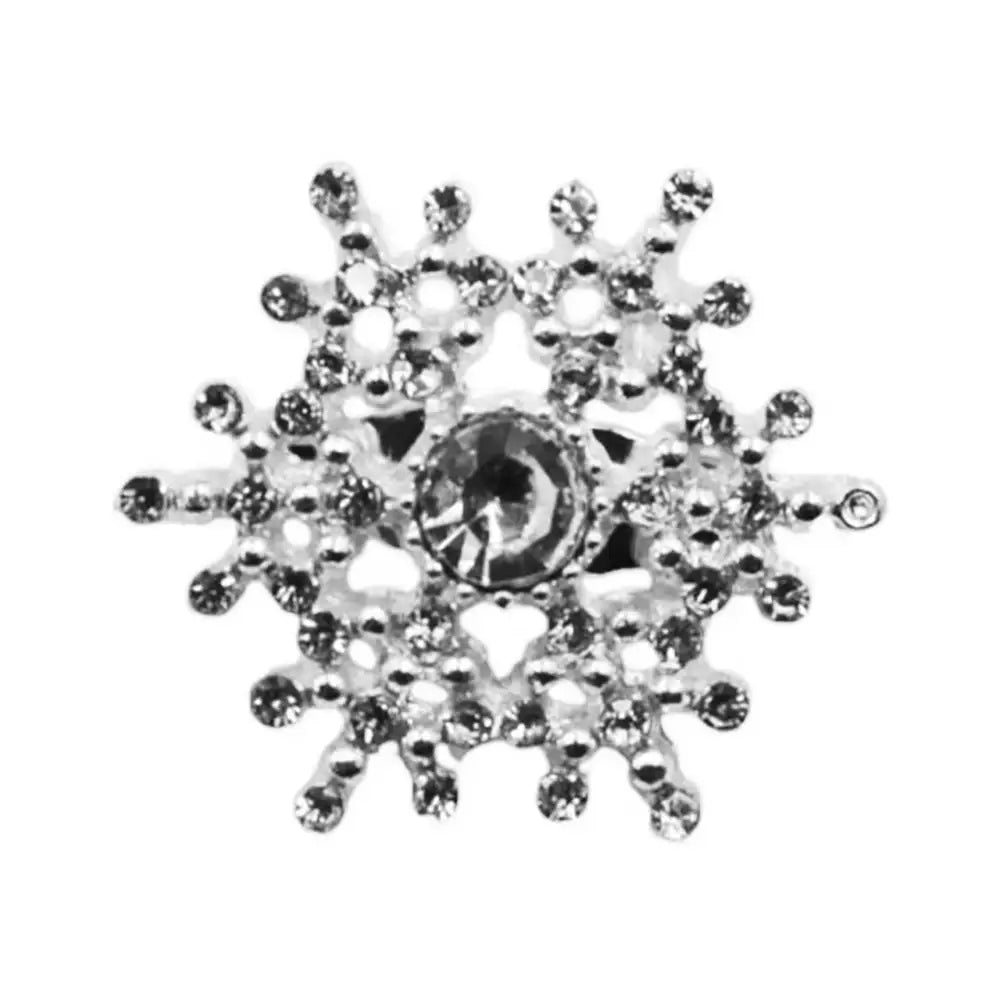 Silver snowflake-shaped charm with clear stones on a white background