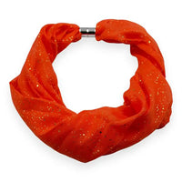 Speckled orange hoop scarf on a white background