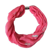 A pink twisted infinity-style fabric bracelet with small silver embroidered details and a silver metal clasp, shown on a plain white background.