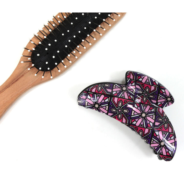 Art Deco hair claw with fuchsia based pattern. Brush shown for scale.