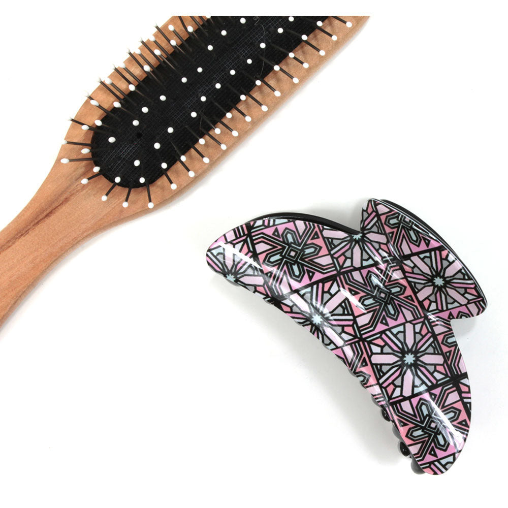 Art Deco hair claw with pink based pattern. Brush shown for scale.