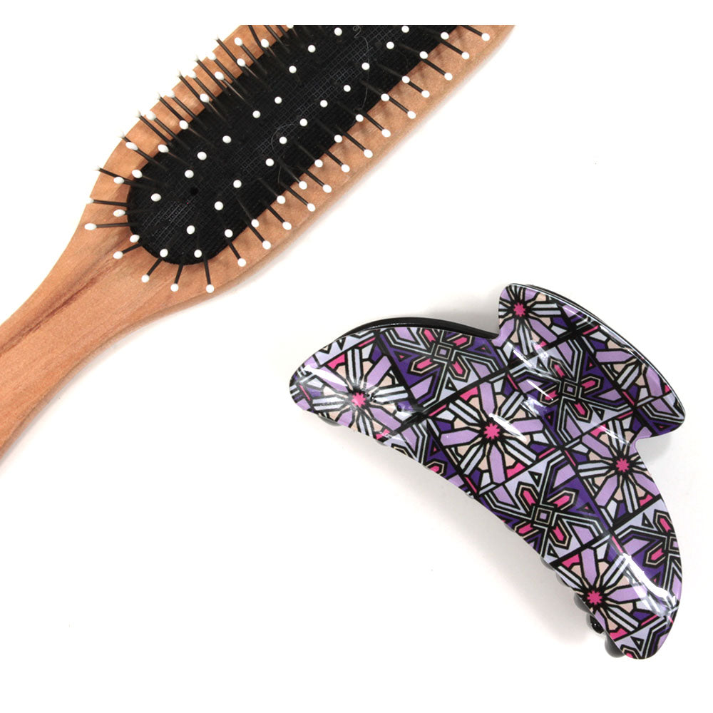 Art Deco hair claw with purple based pattern. Brush shown for scale.