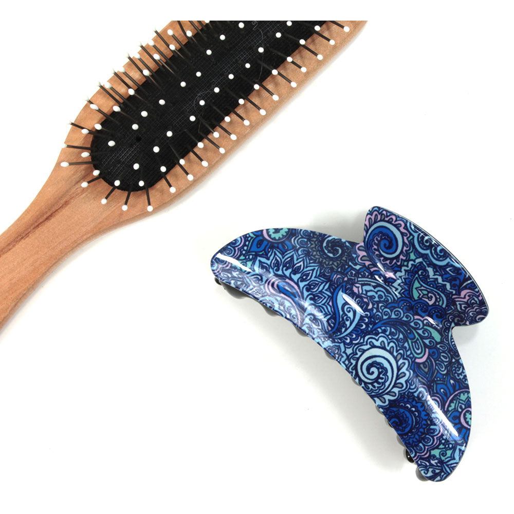 Paisley hair claw with blue based pattern. Brush shown for scale.