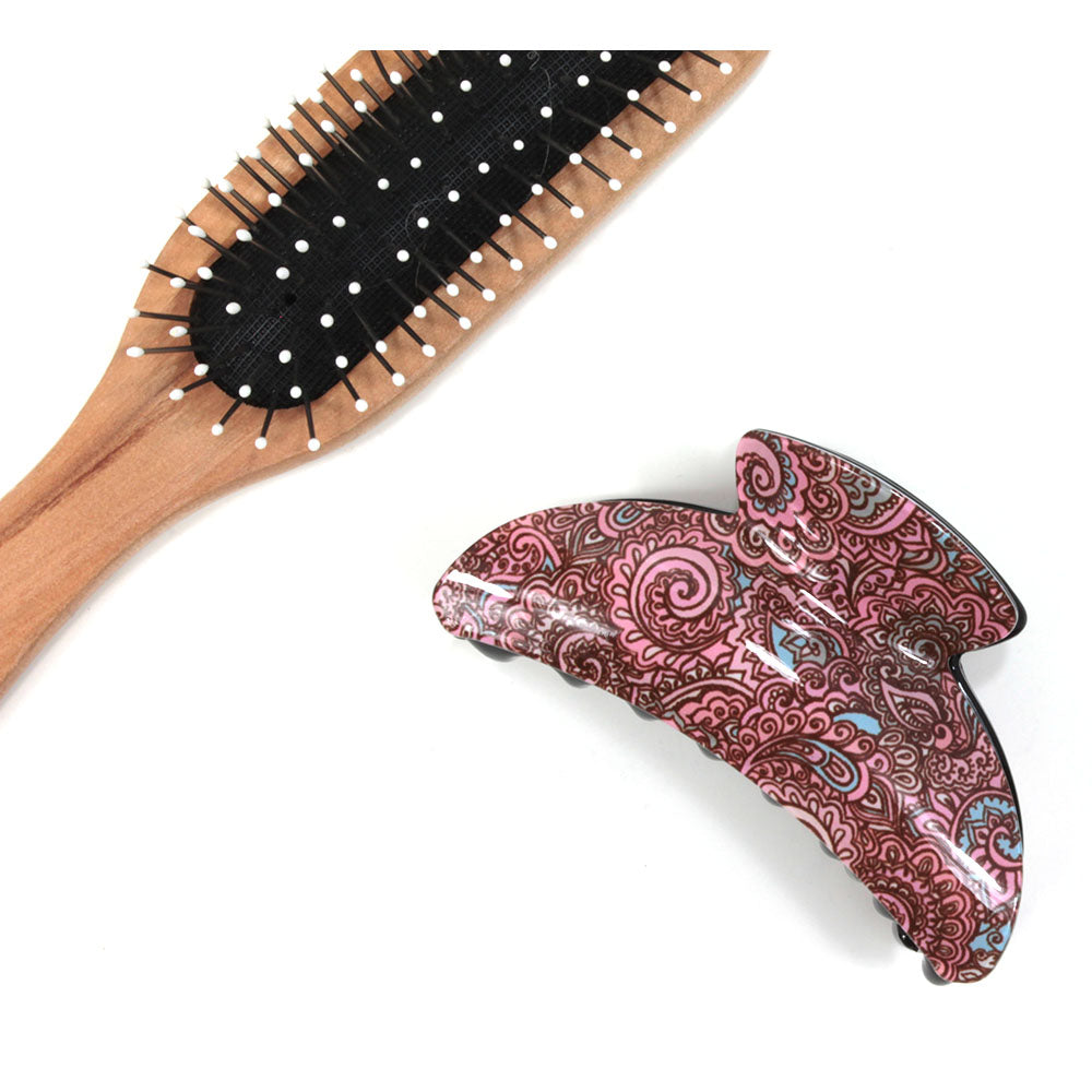 Paisley hair claw with pink based pattern. Brush shown for scale.
