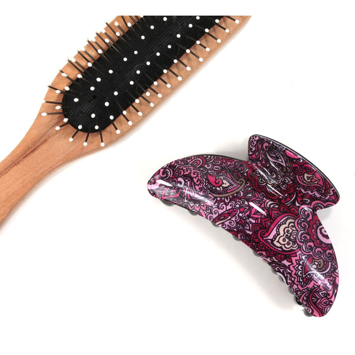 Paisley hair claw with plum based pattern. Brush shown for scale.