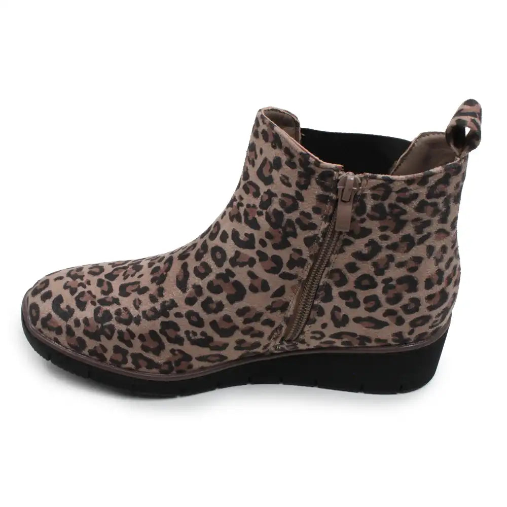A single women's ankle boot with a brown and beige leopard print pattern, featuring a side zipper and a black wedge sole, shown against a plain white background.