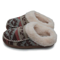 A pair of slip-on slippers with a brown, beige, and red geometric patterned fabric upper and a thick cream faux-fur lining, shown on a white background.