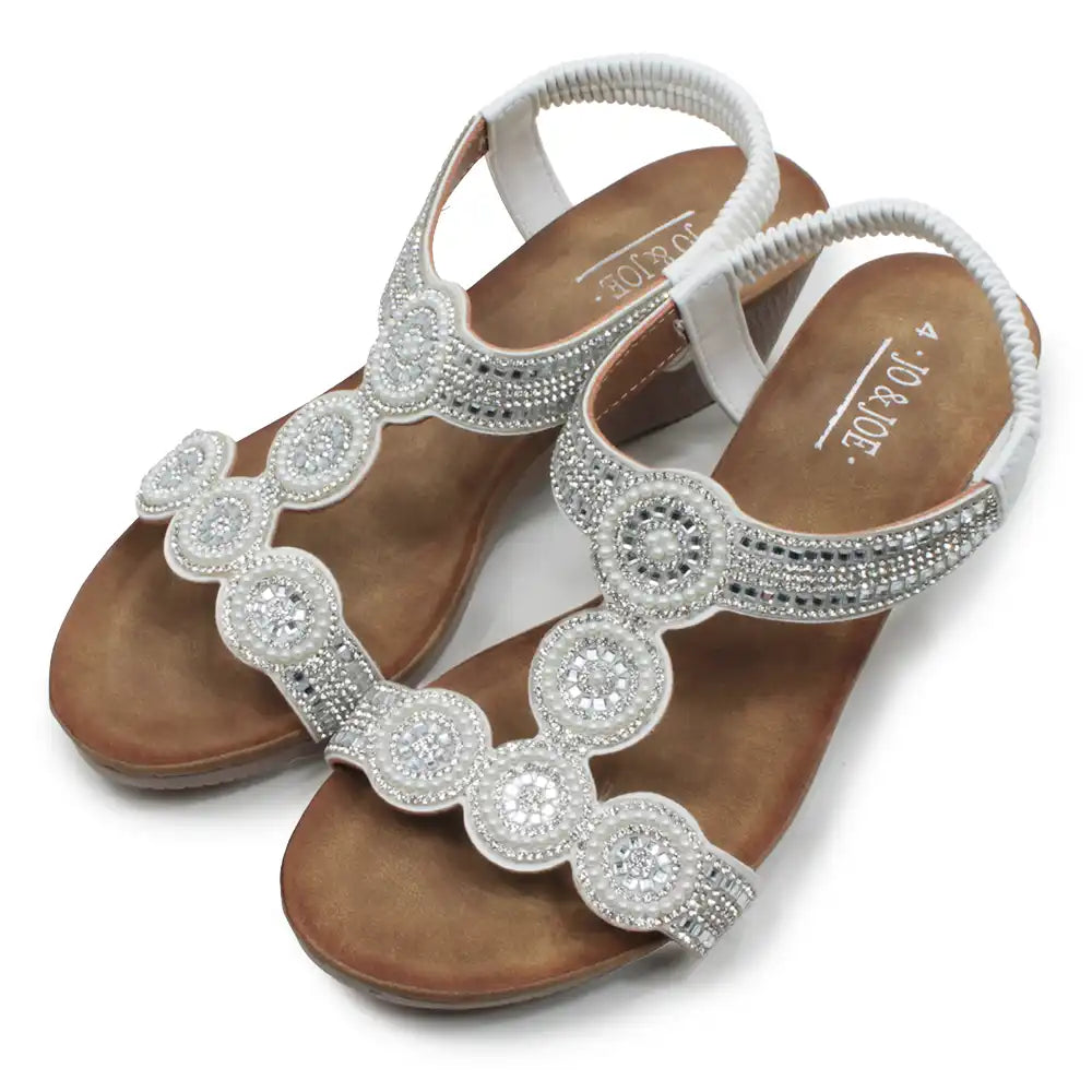 Brown sandals with silver embellishments on a white background