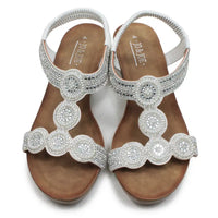 Pair of embellished sandals with 'Jovani' branding on a white background