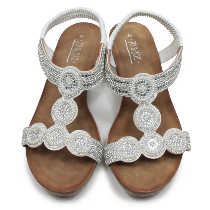 Pair of embellished sandals with 'Jovani' branding on a white background