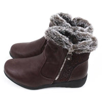 Pair of brown ankle boots with fur trim. Side view.