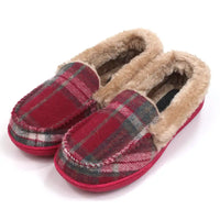 Red tartan full slippers with beige fur ankle collar and lining the inside. Red soles. Angled view.