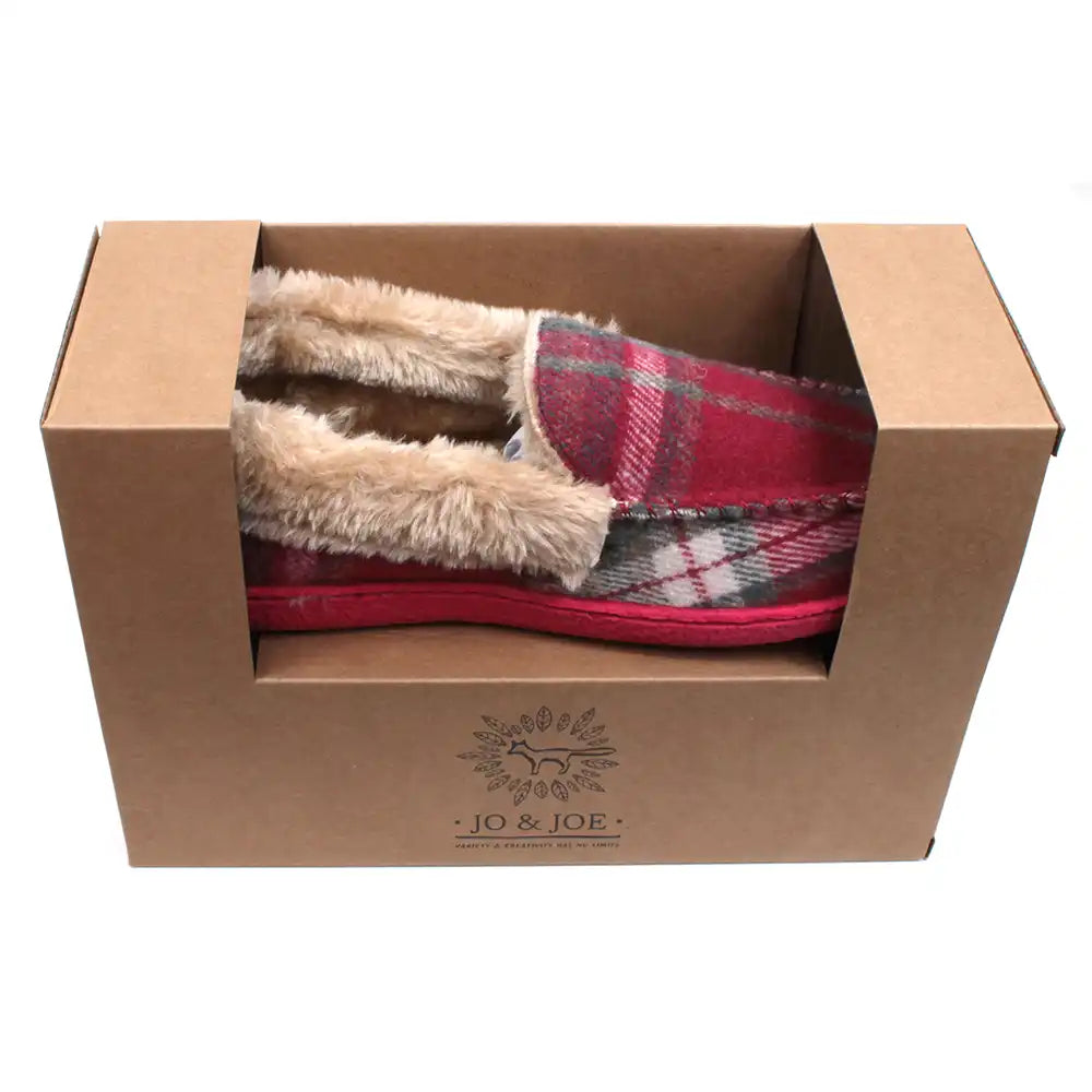 Red tartan full slippers with beige fur ankle collar and lining the inside. Red soles. View showing the slippers in their brown presentation box. Jo and Joe branding on the box.