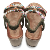 Pair of sandals with braided straps on a white background