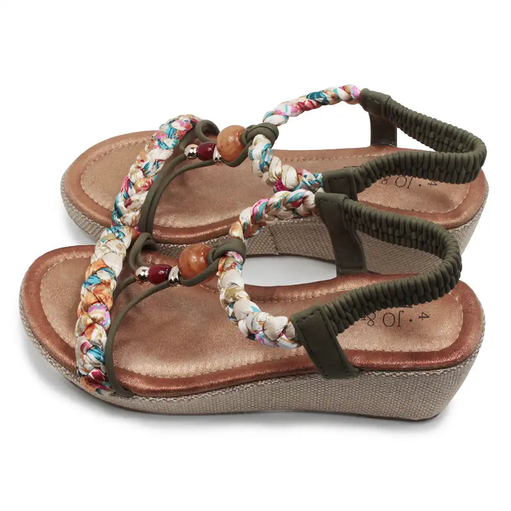 Brown sandal with colorful braided straps on a white background