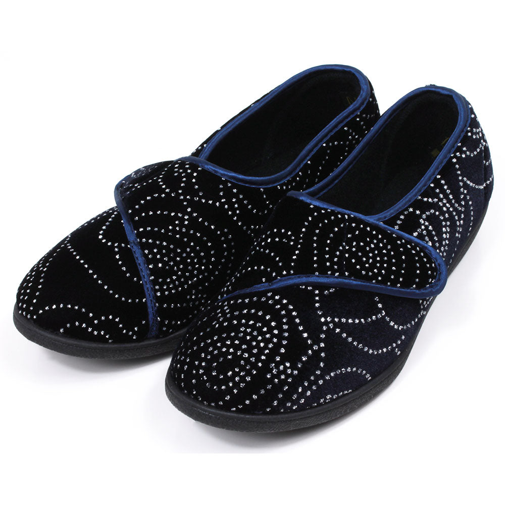 Jo and Joe navy blue full slippers with black soles, extensive small diamante patterning and wrap over Velcro fitting. Angled view.