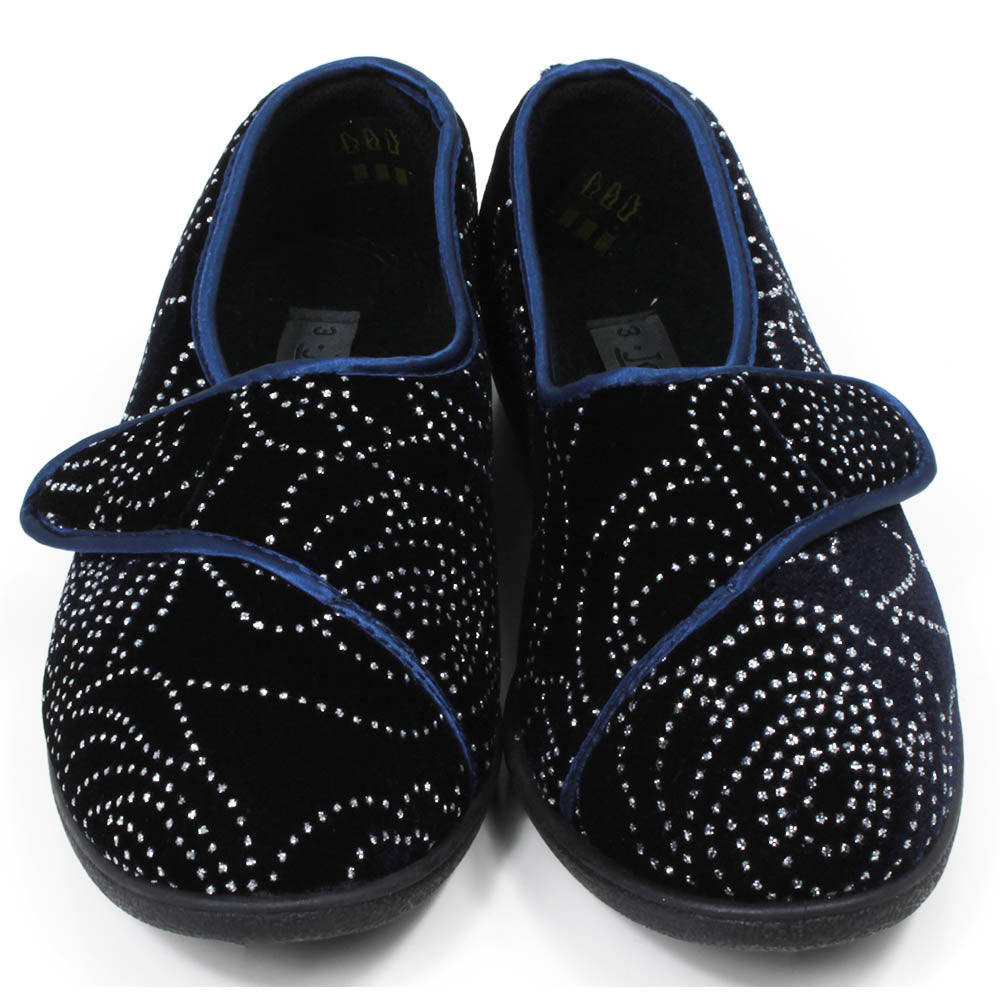 Jo and Joe navy blue full slippers with black soles, extensive small diamante patterning and wrap over Velcro fitting. Front view.