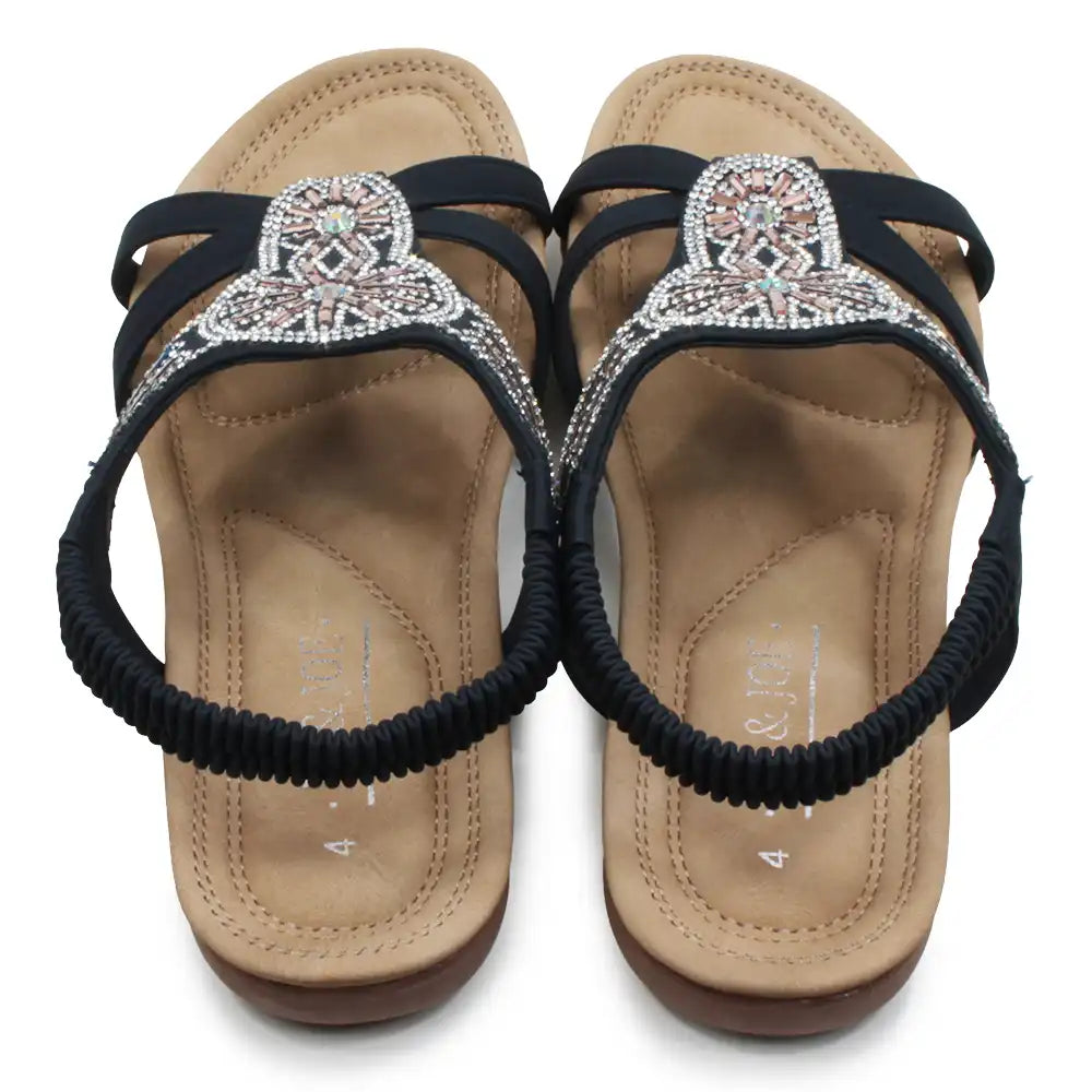 Pair of sandals with decorative straps on a white background