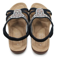 Pair of sandals with decorative straps on a white background