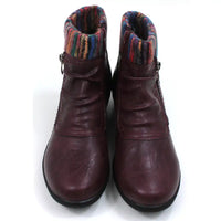 Burgundy ankle boots with knitted multicolour ankle cuffs. Zip fastening. Low  heels. Front view.