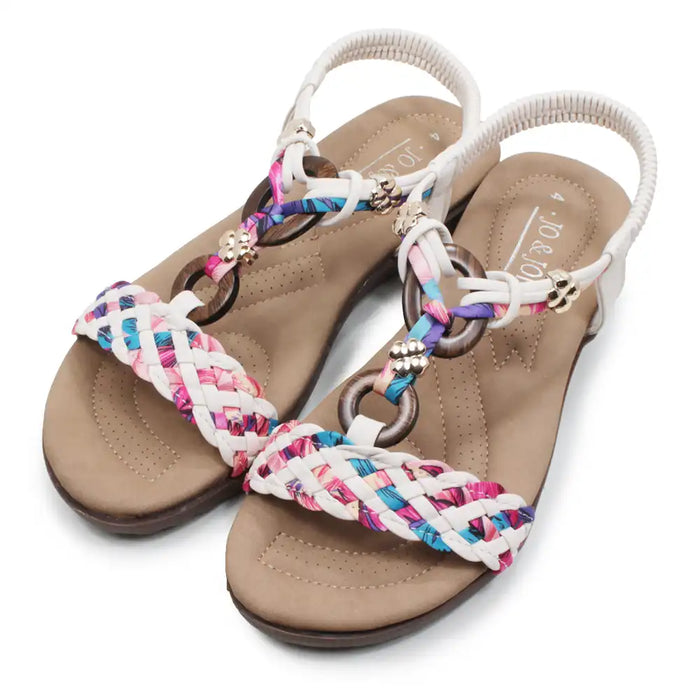Beige sandals with colorful braided straps on a white background