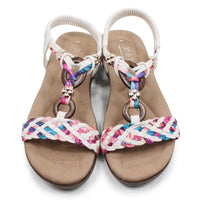 Pair of sandals with colorful braided straps on a white background