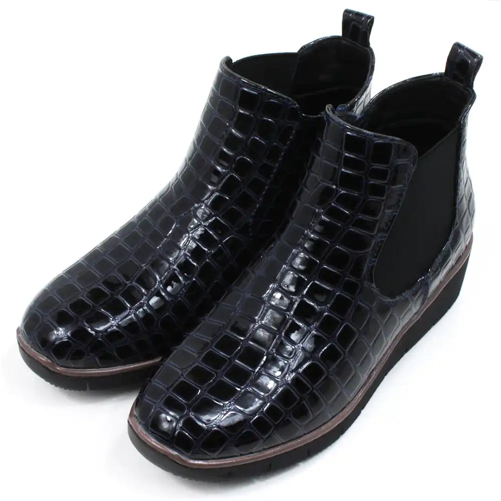 Mock croc navy blue Chelsea boots. Low heels. Angled view.