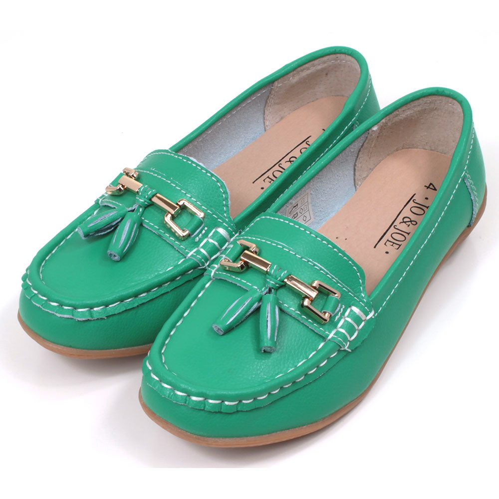 Jo and Joe Nautical mocassin style slip on shoes in emerald. Gold bar and tassels details on foot. Angled view
