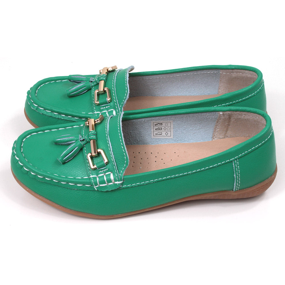 Jo and Joe Nautical mocassin style slip on shoes in emerald. Gold bar and tassels details on foot. Side view