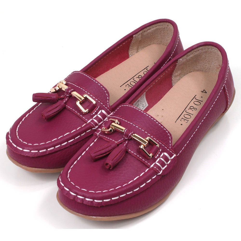 Jo and Joe Nautical mocassin style slip on shoes in fuchsia. Gold bar and tassels details on foot. Angled view
