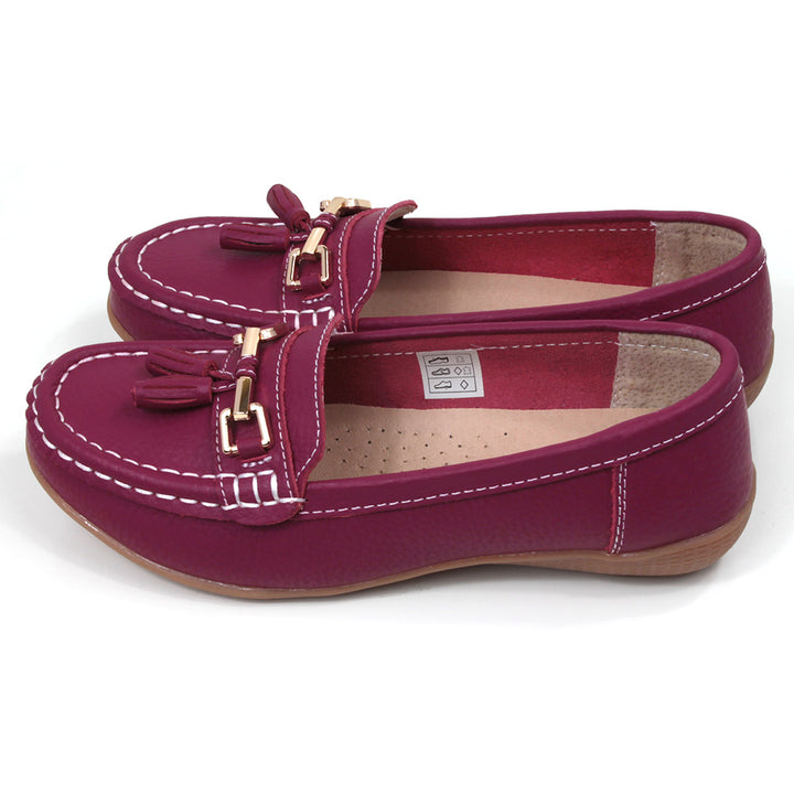 Jo and Joe Nautical mocassin style slip on shoes in fuchsia. Gold bar and tassels details on foot. Side view