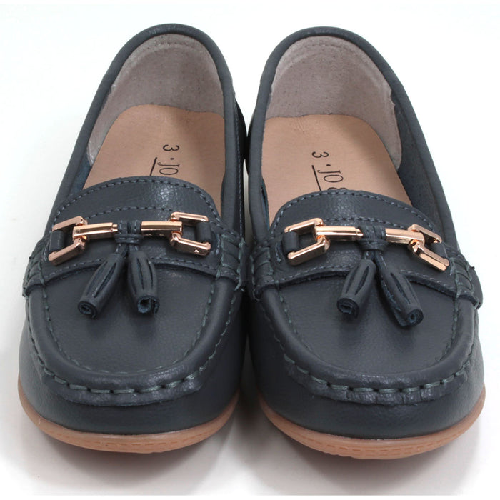 Joe and Jo moccasin style slip on, leather shoes in slate colour. Over the foot metallic gold coloured  detail and two matching tassels. Beige rubber soles. Front view.